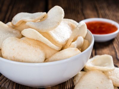 Fresh made Prawn Crackers (Krupuk) on wooden background; Shutterstock ID 274183907